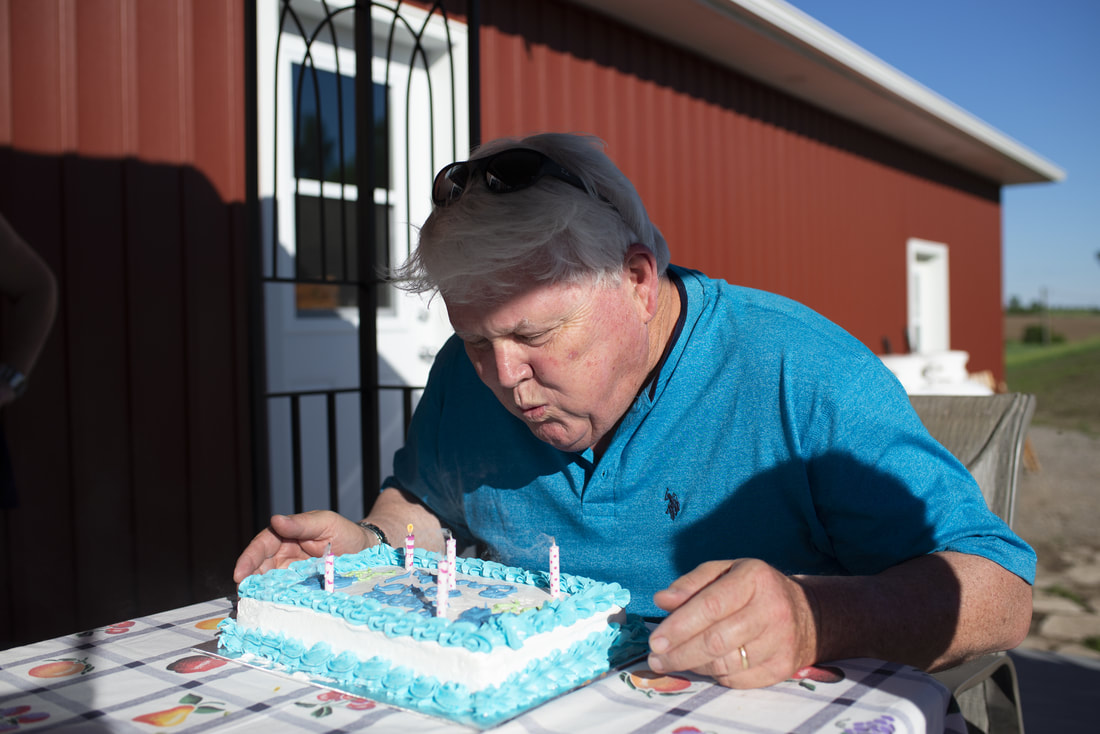 Man blowing out his birthday candles