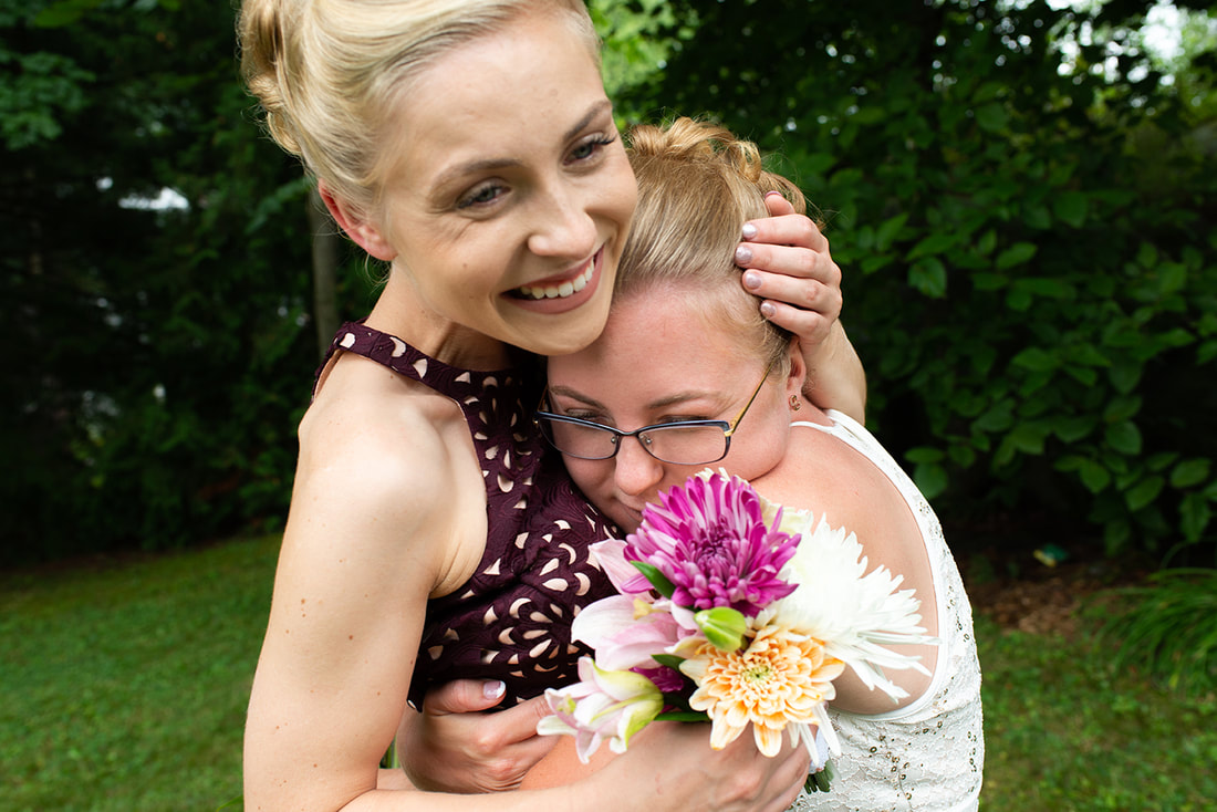 Two women embracing at a wedding